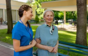 charming nurse talking with a patient whole holding her arm