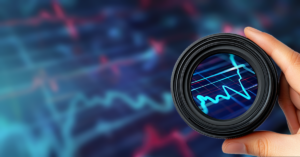 A hand holding a camera lens sharpens the focus of the underlying image to demonstrate the effect of radar frequency on the detail of contactless patient monitoring vital sign data.