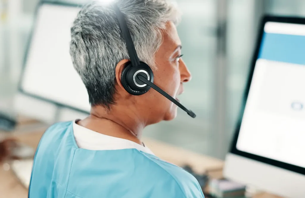 Nurse in a remote monitoring service provider call hub reviews patient data.