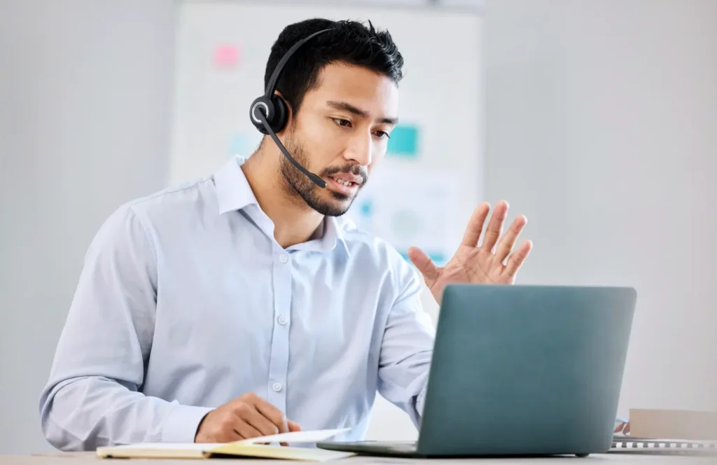 Care manager wearing a headset on a call with a patient while reviewing trend data.