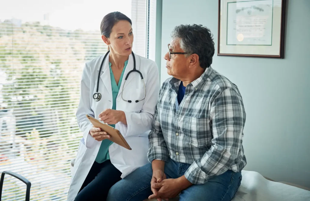 Doctor consults with patient during in office visit.